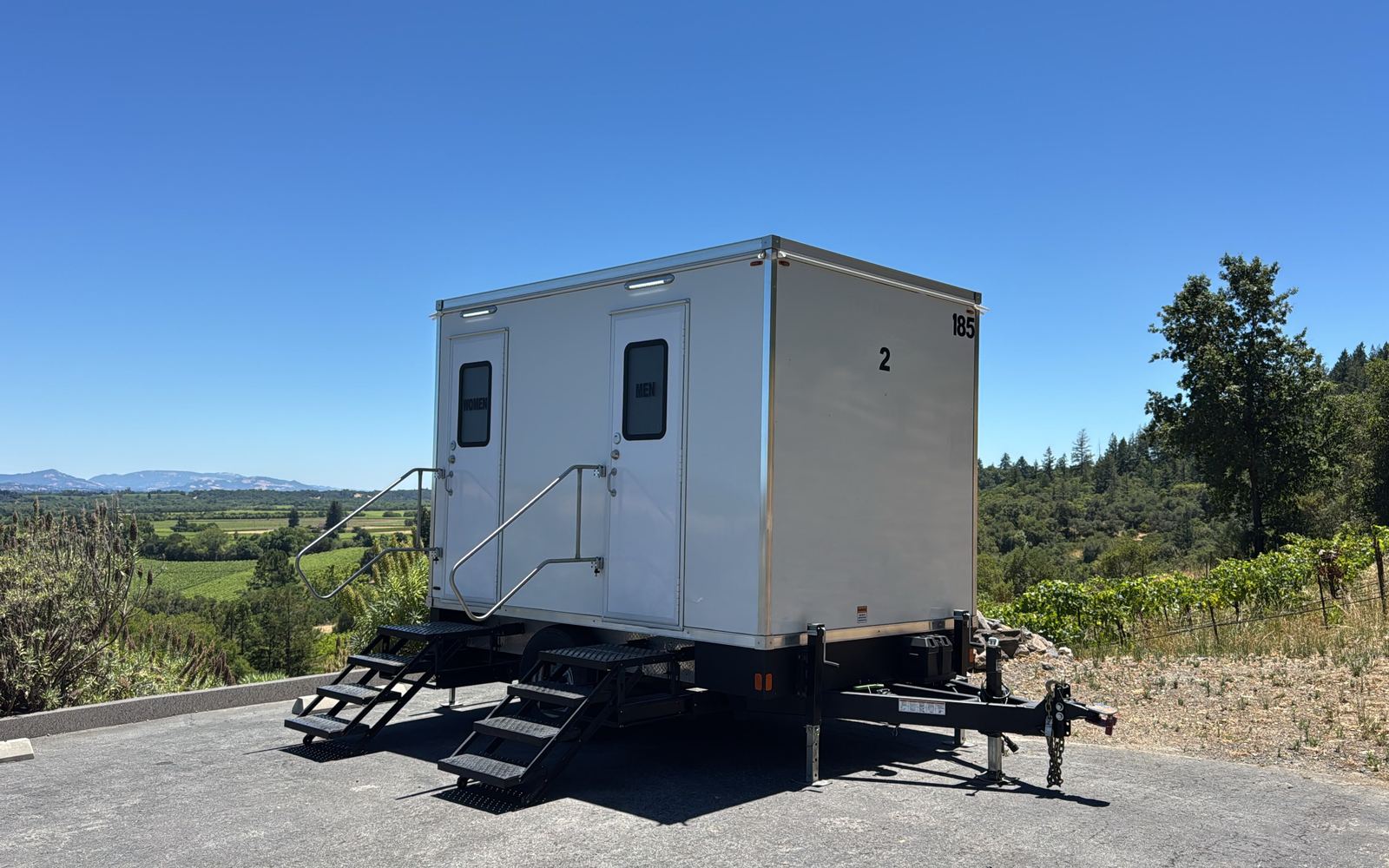 2-stall luxury bathroom trailer on a hilltop above a vineyard, The Lavatory NorCal