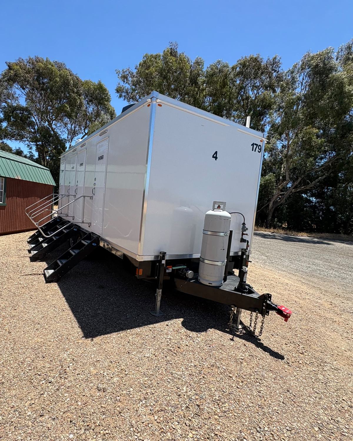 8-stall shower trailer with railed stairs and a propane tank, ready for a fire camp or a long job, The Lavatory NorCal