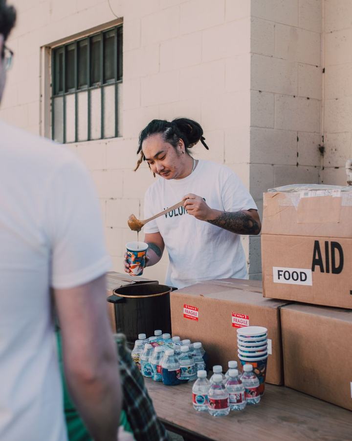 Relief volunteers handing out food and supplies, a use case for The Lavatory NorCal emergency restroom and shower trailers