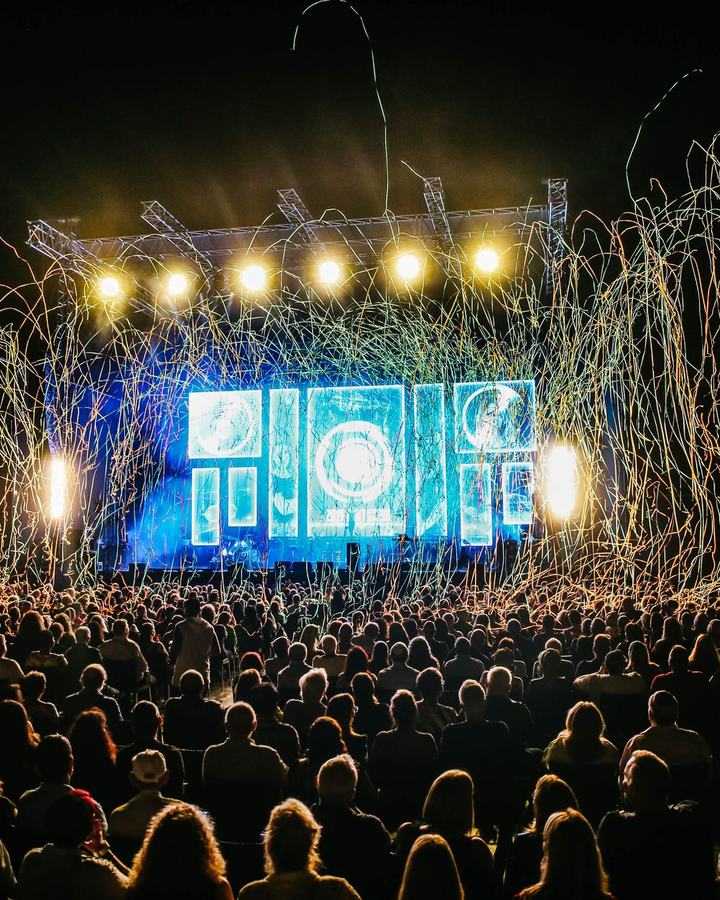 Concert crowd in front of a lit festival stage, a use case for The Lavatory NorCal restroom trailers