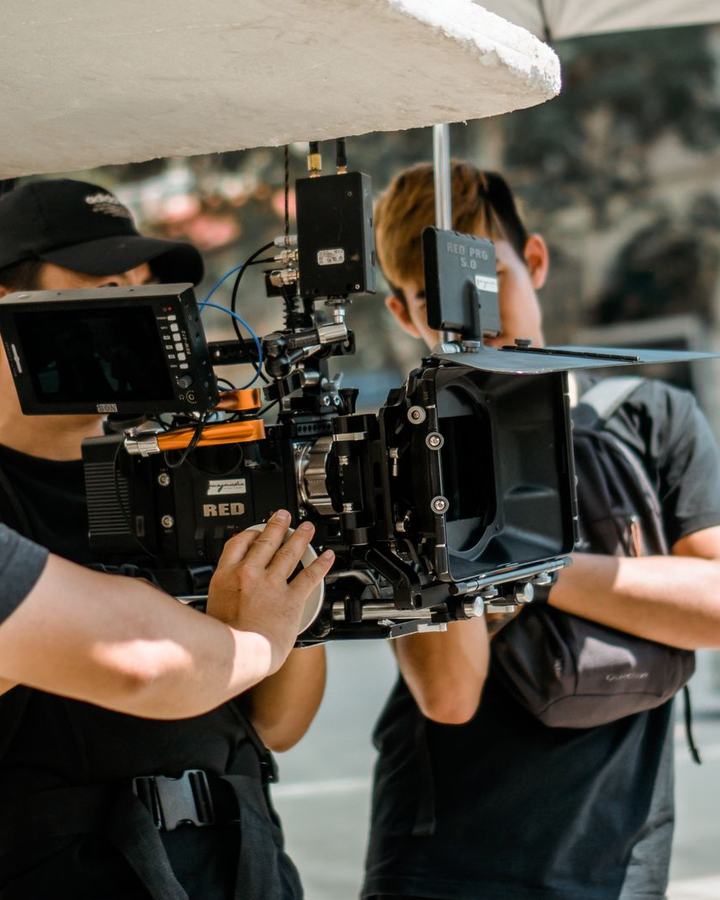 Film crew operating a cinema camera on an outdoor set, a use case for The Lavatory NorCal restroom trailers