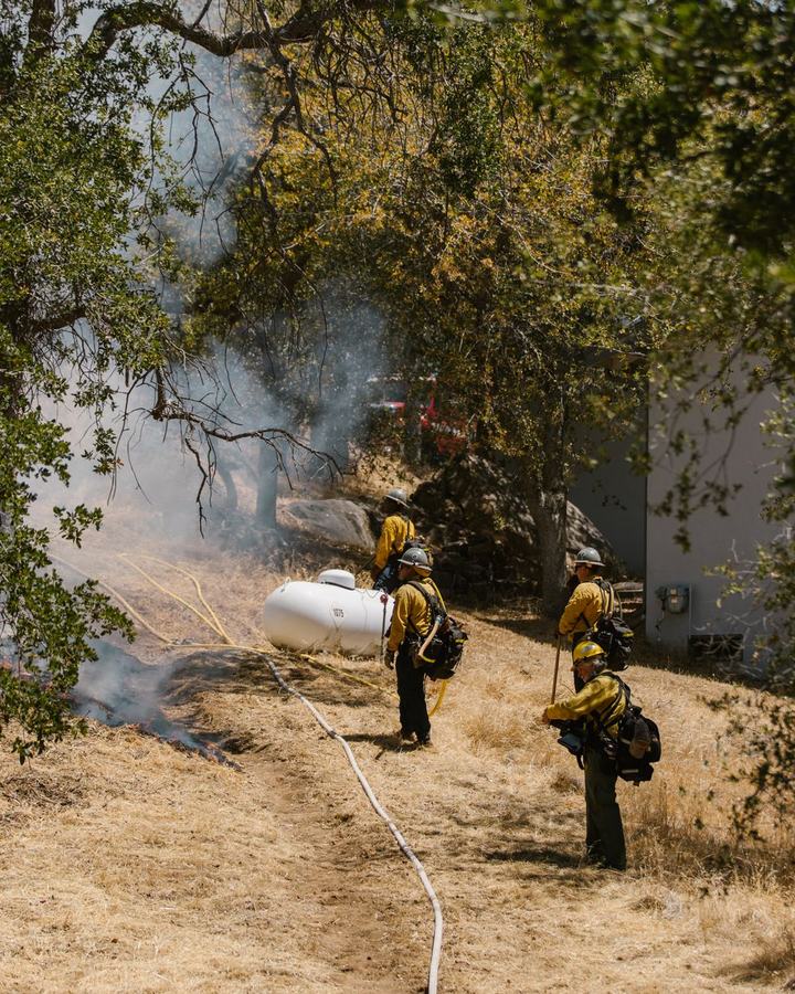 Wildland firefighters working a fire line, a use case for The Lavatory NorCal fire camp shower and restroom trailers