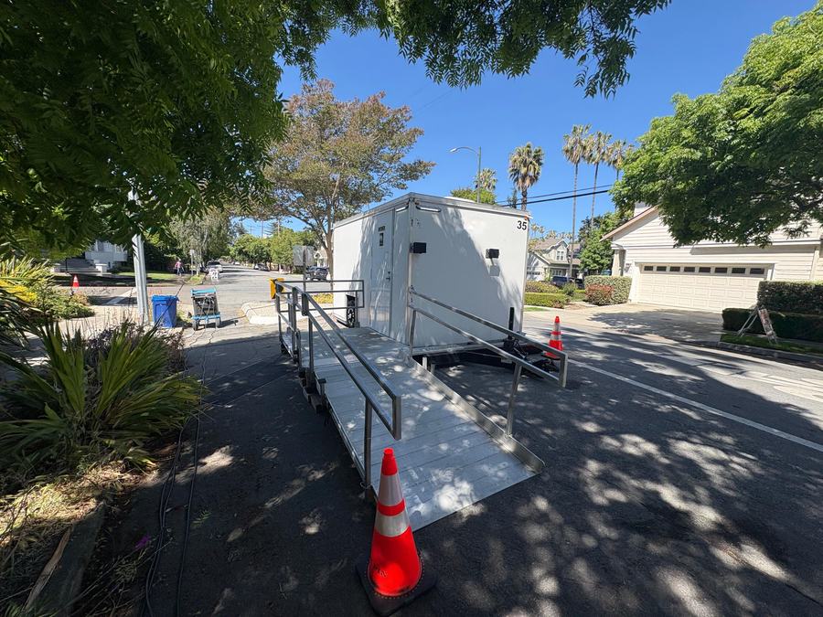 ADA shower and restroom combo trailer with a railed ramp on a street film set in San Jose, The Lavatory NorCal