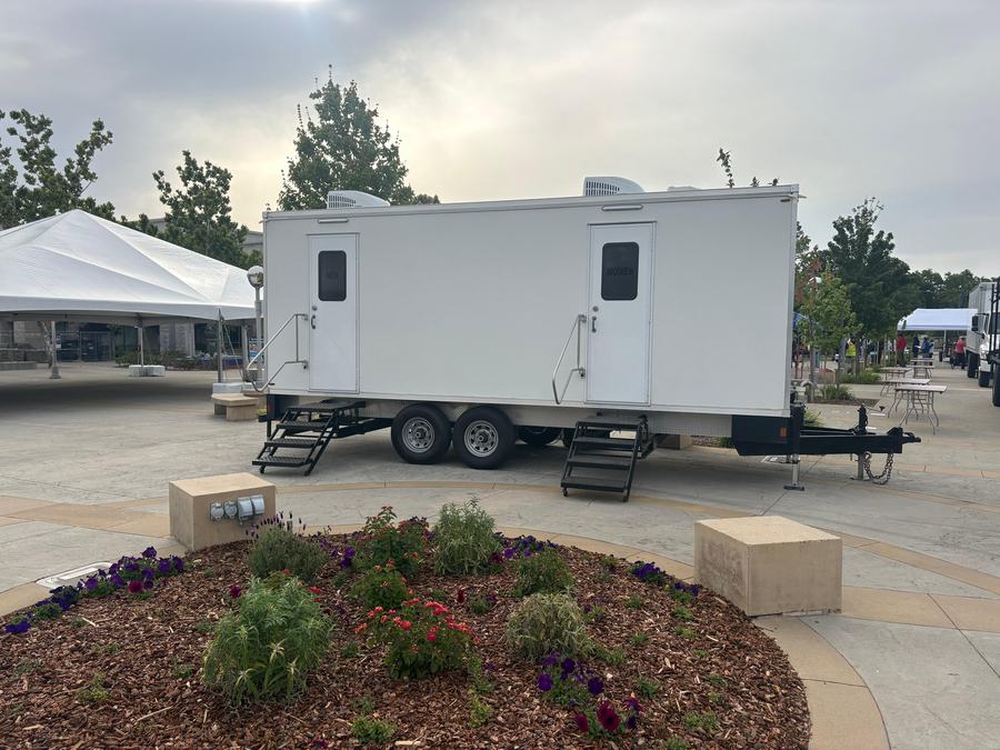 9-stall restroom trailer on the event plaza beside the tents for a Rotary Club event in Roseville, The Lavatory NorCal