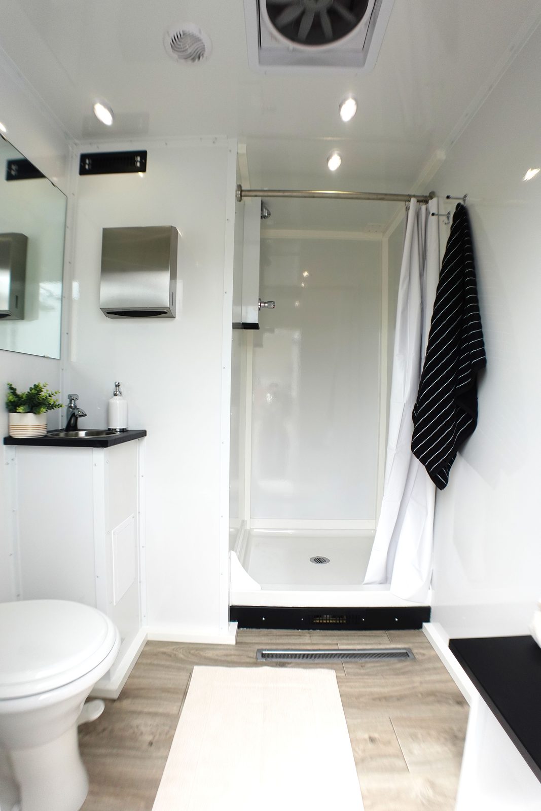Private room in the 2-stall shower and restroom combo: walk-in shower, toilet, vanity and bench, The Lavatory NorCal