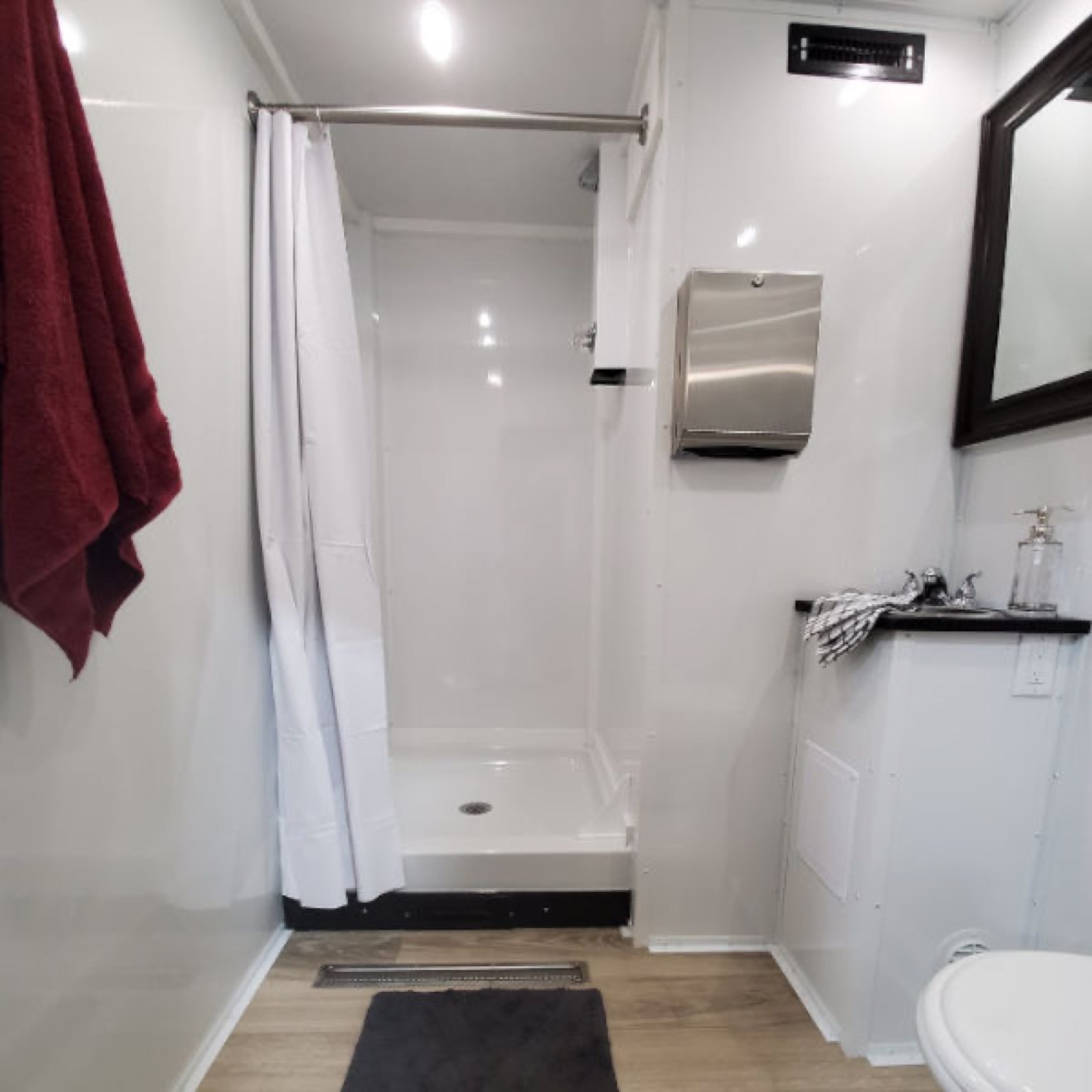 Walk-in shower, sink and toilet inside a private shower and bathroom trailer room, The Lavatory NorCal