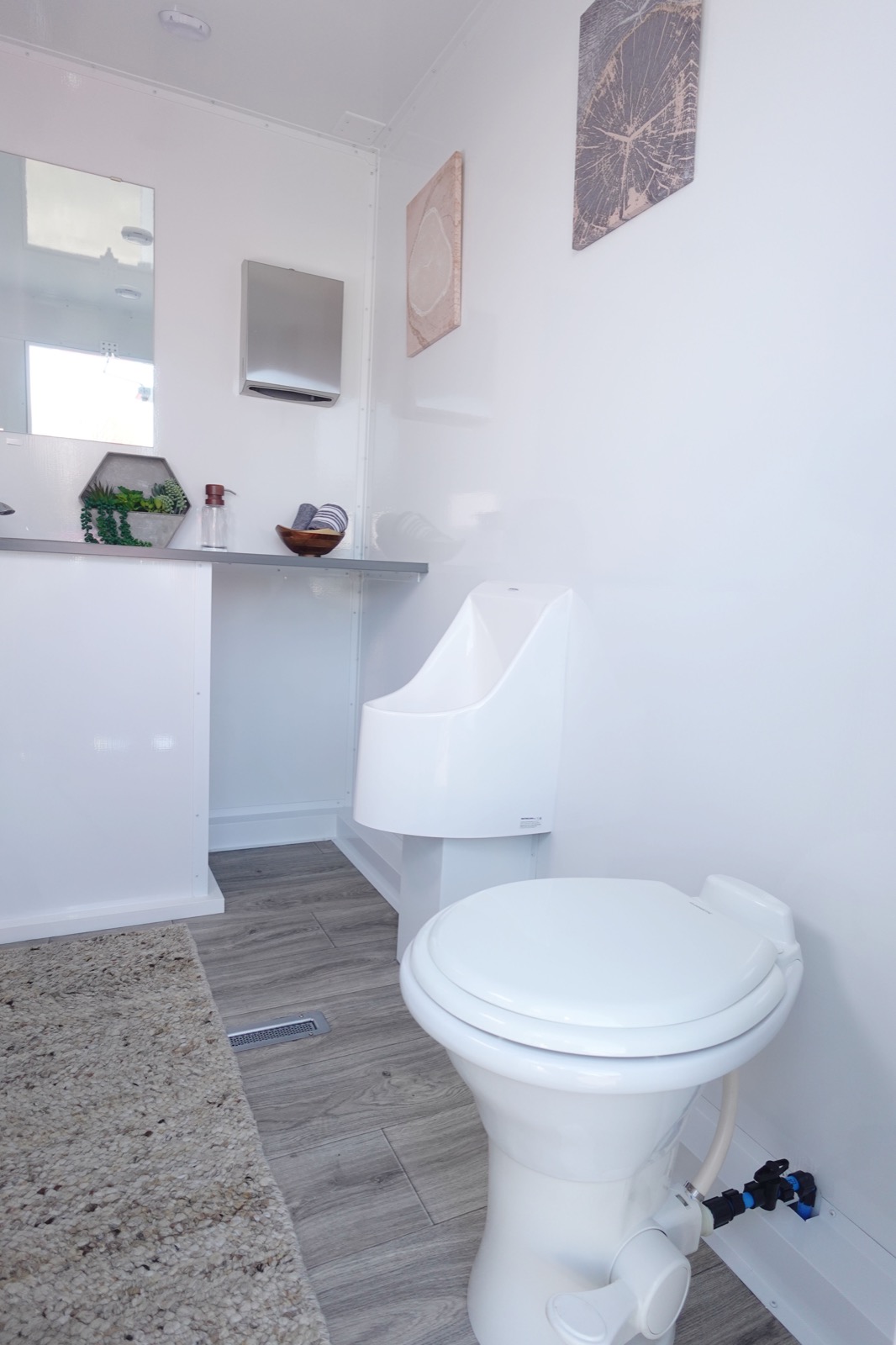 Men's room in a 3-stall portable bathroom trailer with a urinal, toilet and counter, The Lavatory NorCal