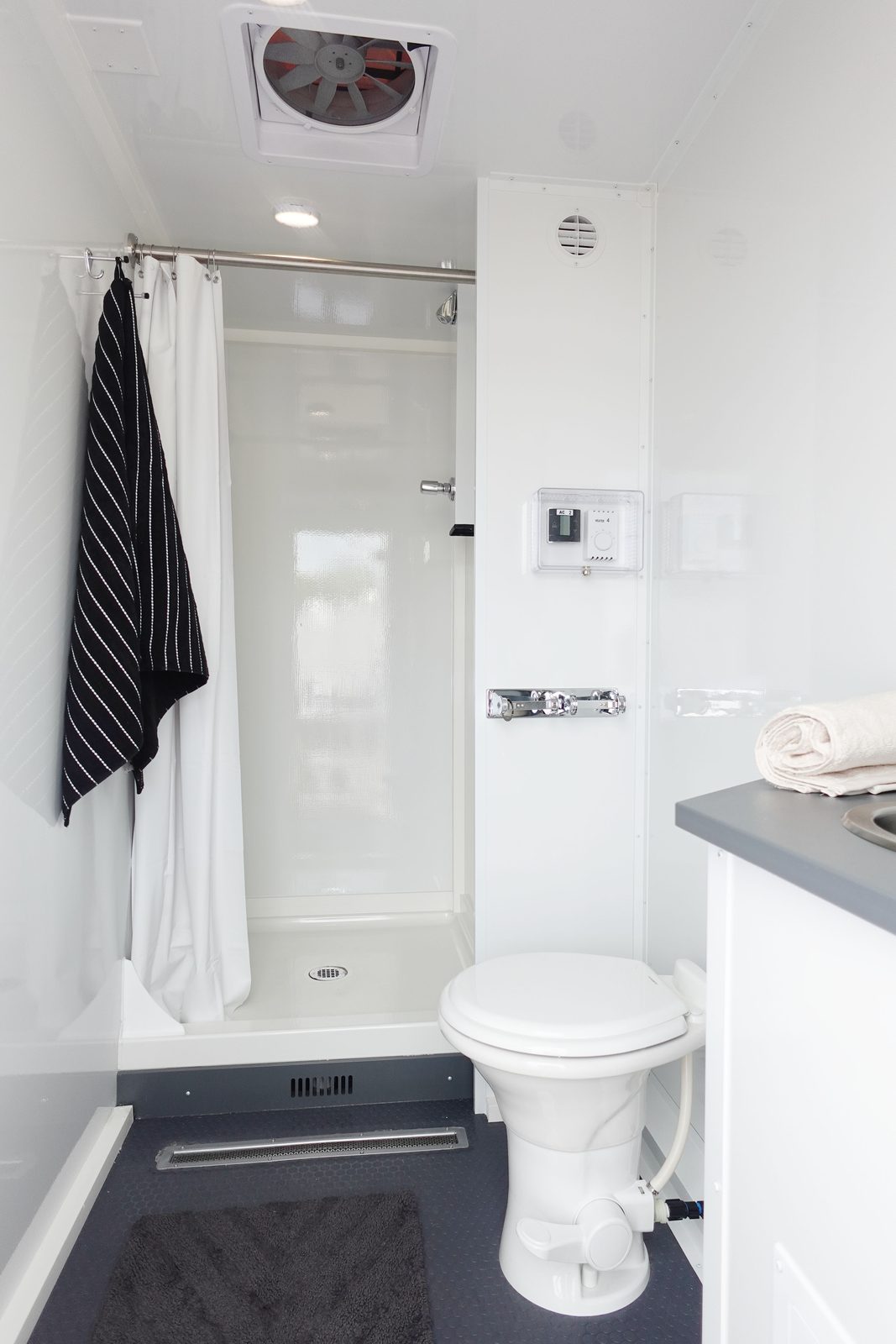 Shower and toilet room inside the 4-stall combo trailer that also carries a laundry room, The Lavatory NorCal