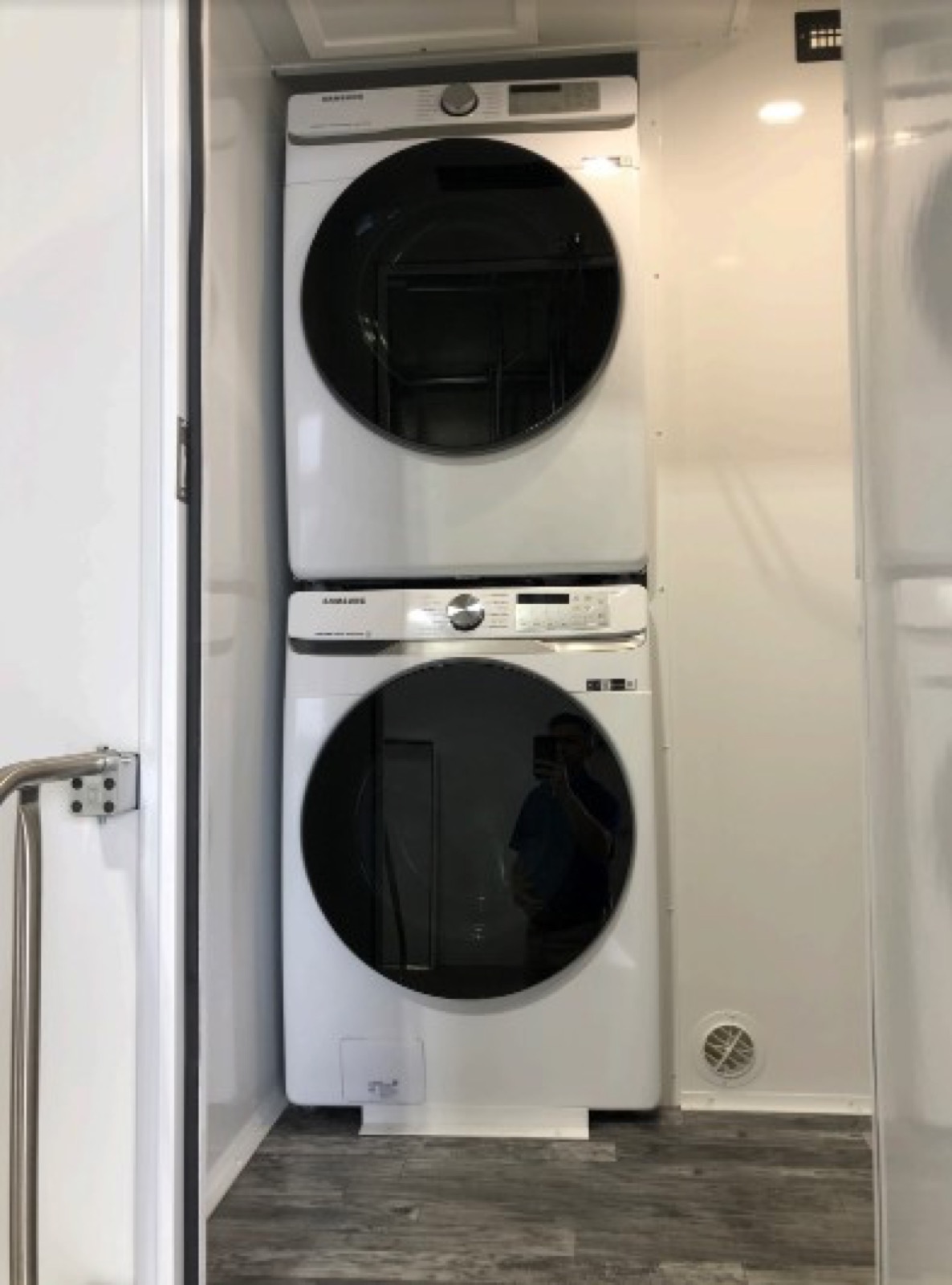 Stacked washer and dryer in the separate laundry room of the 4-stall combo trailer, The Lavatory NorCal