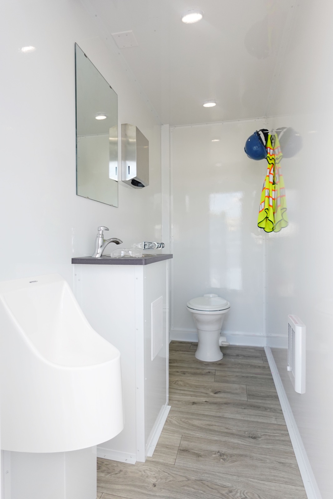 Inside one private stall of the 8-stall bathroom trailer with a urinal, a sink and a china toilet, The Lavatory NorCal