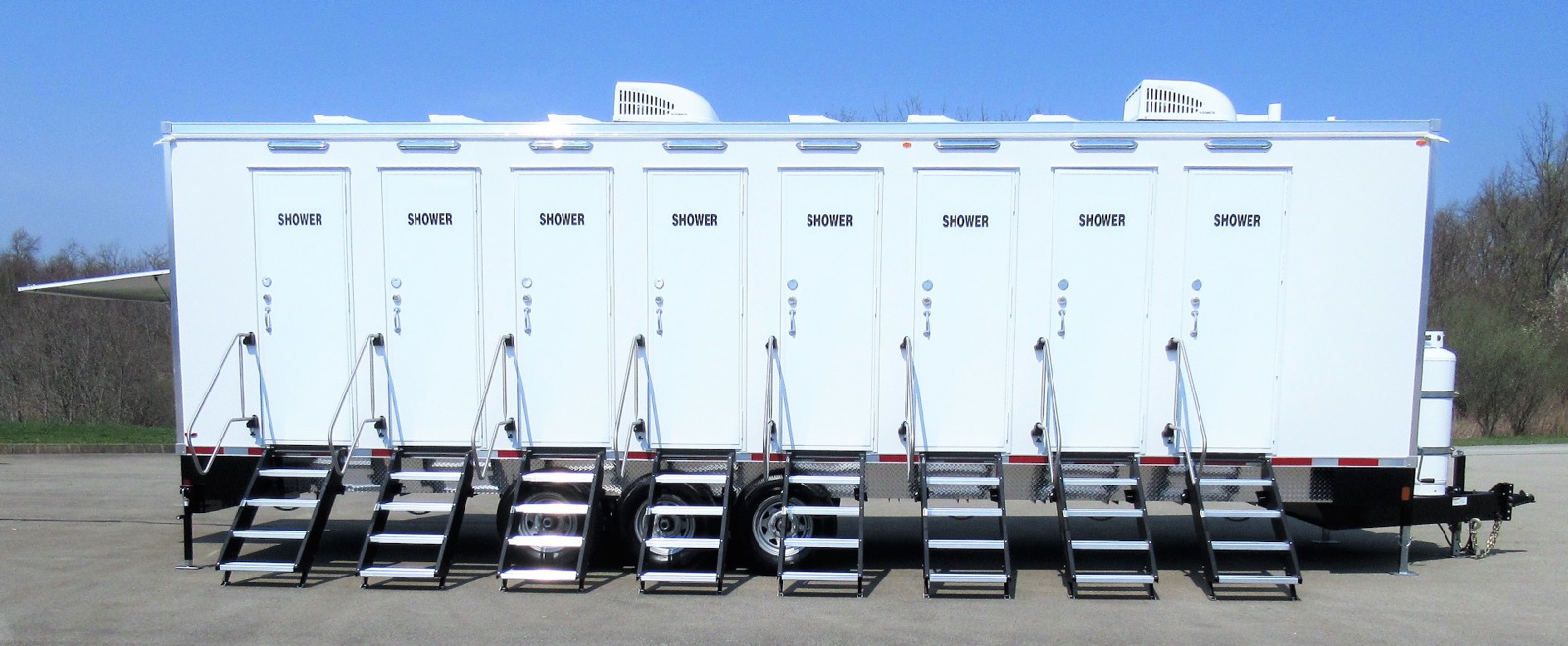 Side view of an 8-stall shower trailer with eight private shower doors, The Lavatory NorCal