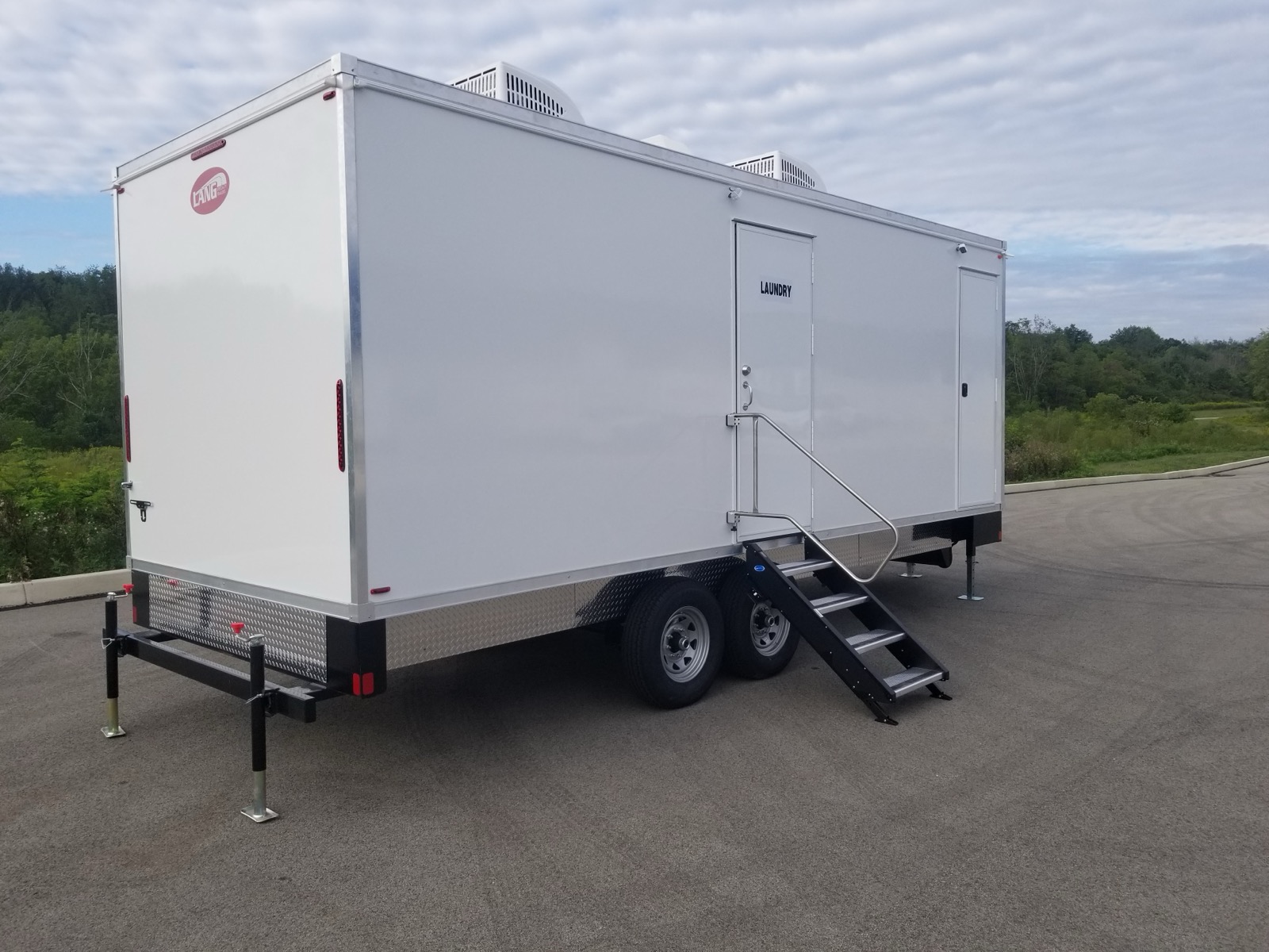 8-station laundry trailer with entry stairs parked on open pavement, The Lavatory NorCal