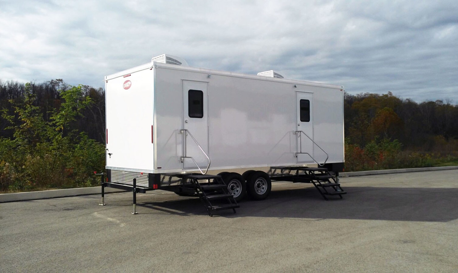 9-stall bathroom trailer with two entry stairs, often paired with an accessible unit at large events, The Lavatory NorCal