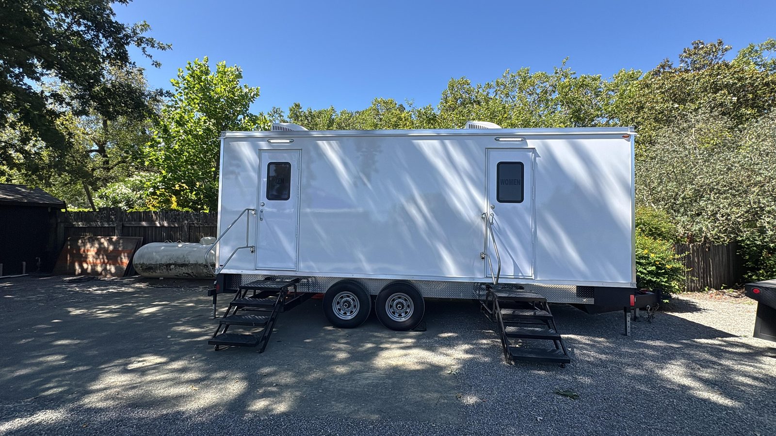 9-stall bathroom trailer on a shaded gravel lot in Rutherford in the Napa Valley, The Lavatory NorCal