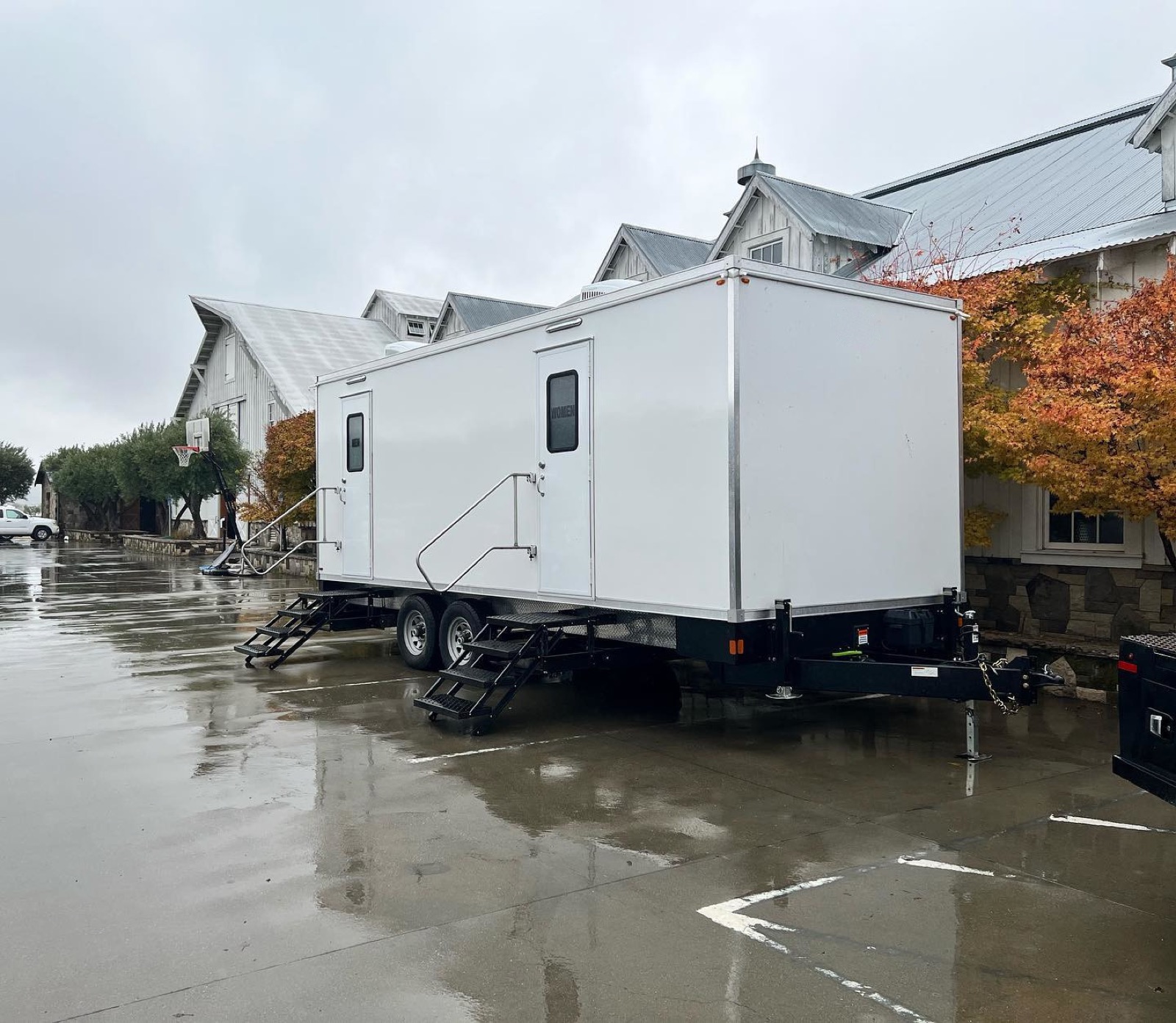 9-stall restroom trailer parked by a winery building on a rainy fall day, The Lavatory NorCal