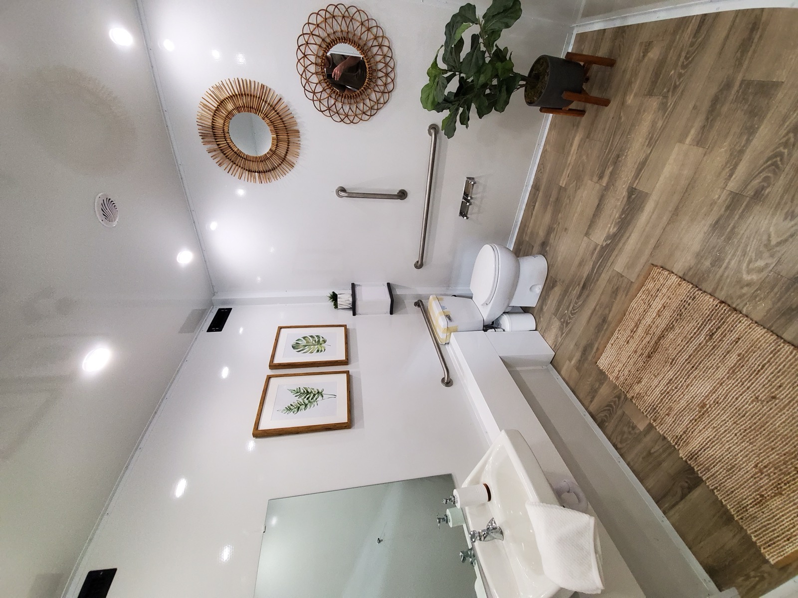 Clean accessible room with grab bars, a china toilet and a sink inside an ADA plus 2 restroom trailer, The Lavatory NorCal