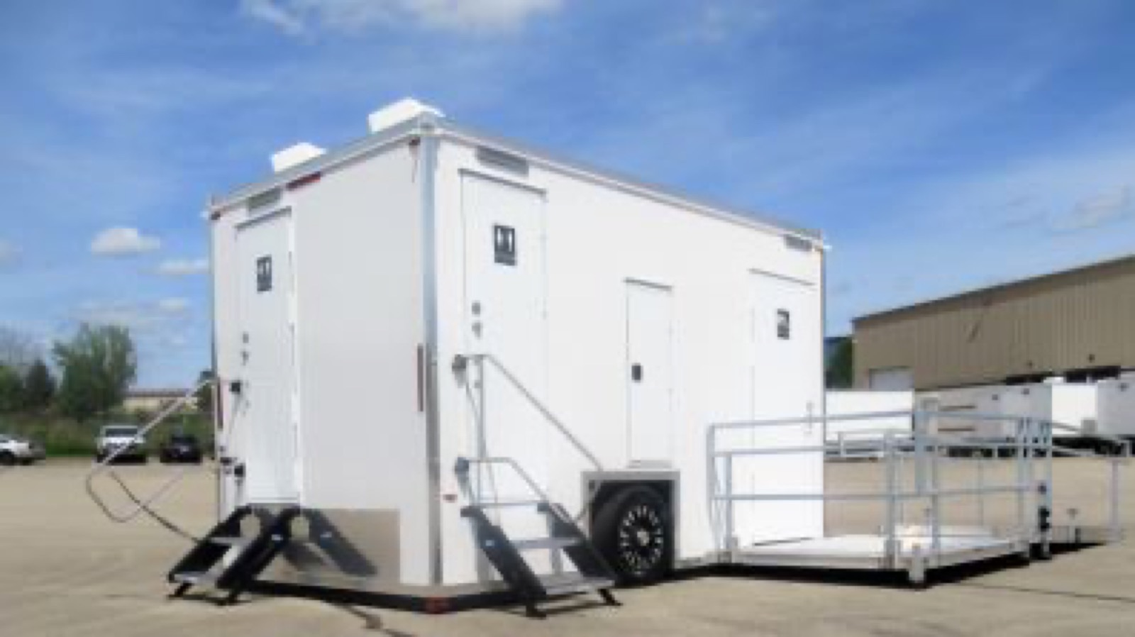 ADA plus 2 shower trailer in our yard with stairs to the standard rooms and the accessible platform folded out, The Lavatory NorCal