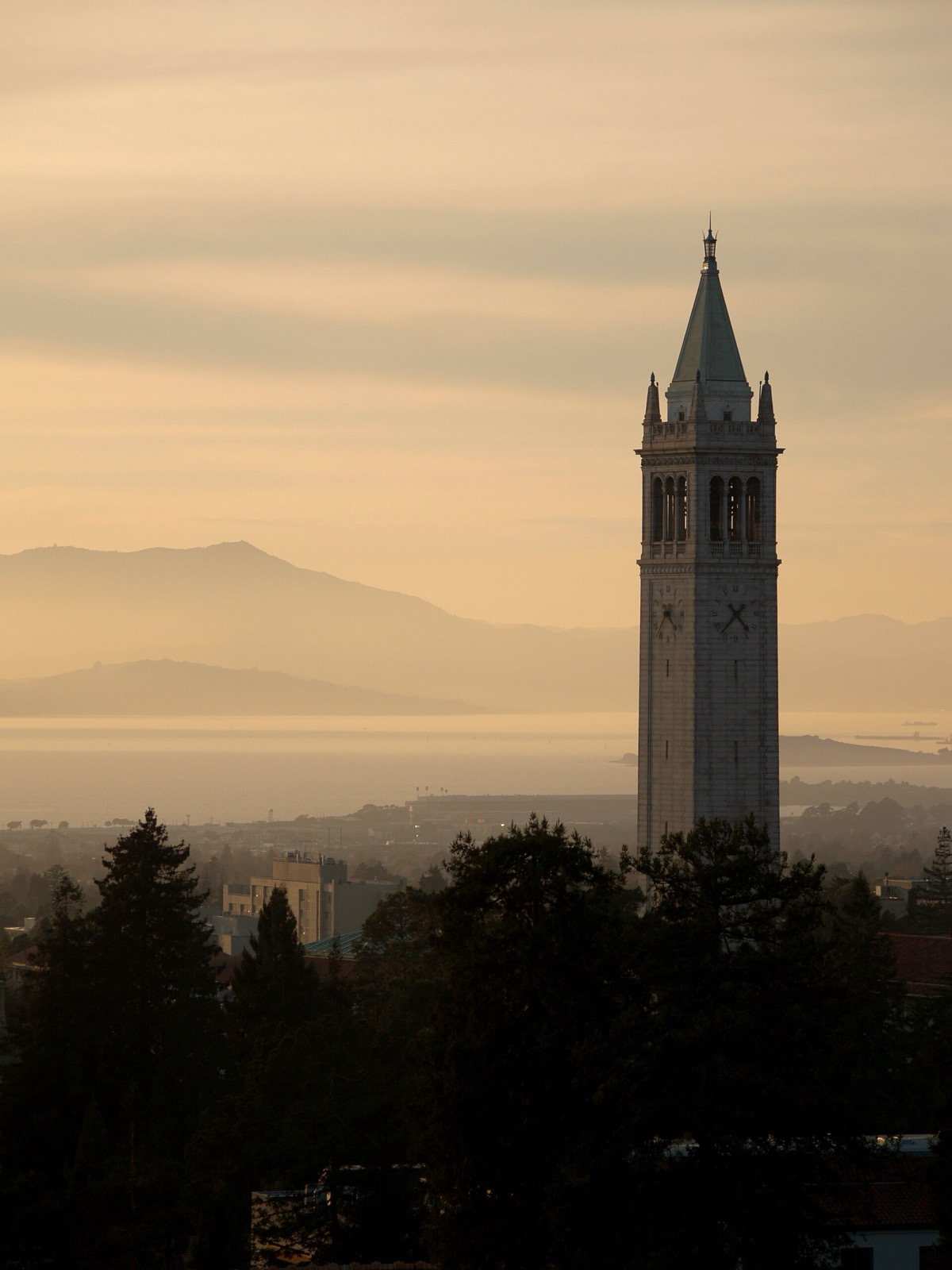Sather Tower on the UC Berkeley campus at sunset with the bay and Mount Tamalpais behind it, an area served by The Lavatory NorCal
