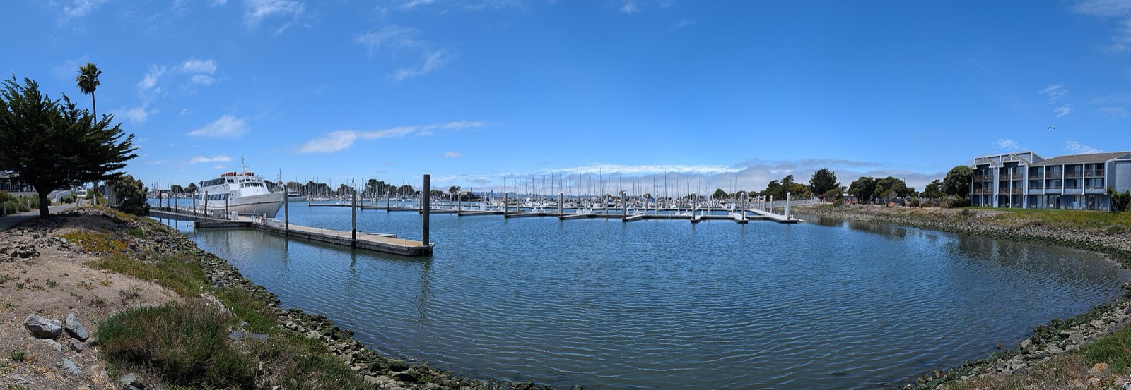 Boat docks and open water at the Berkeley Marina on a clear day, a waterfront area served by The Lavatory NorCal