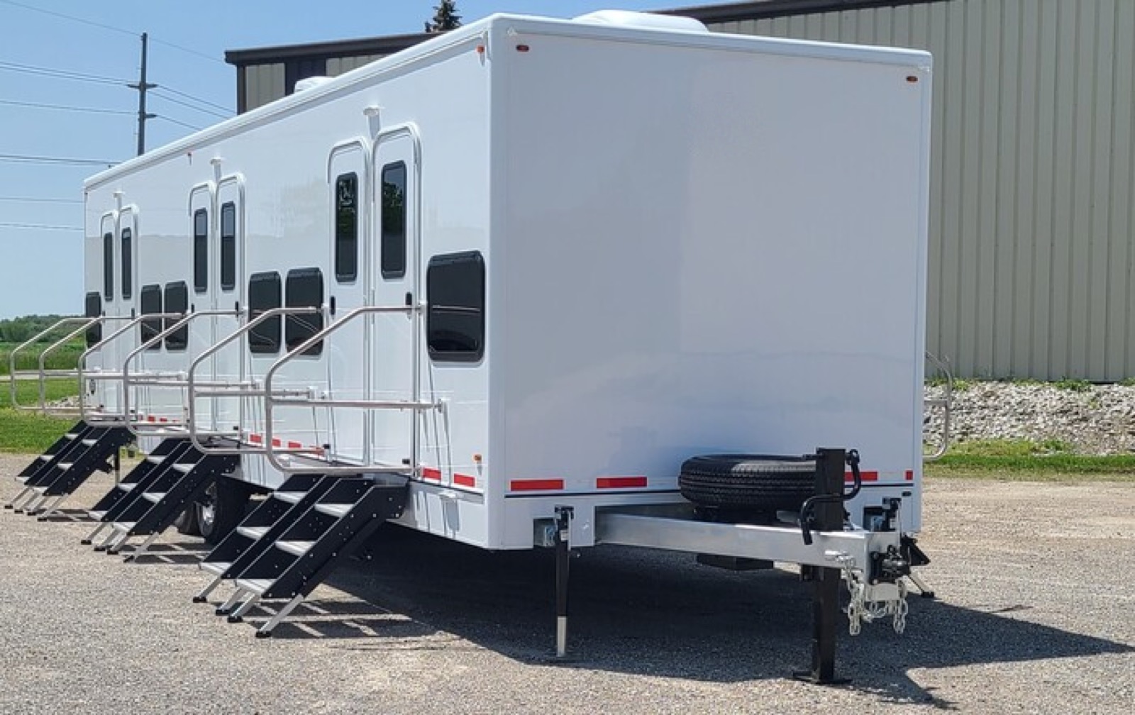12-station bunkhouse sleeper trailer with stairs up to each bunk door, The Lavatory NorCal