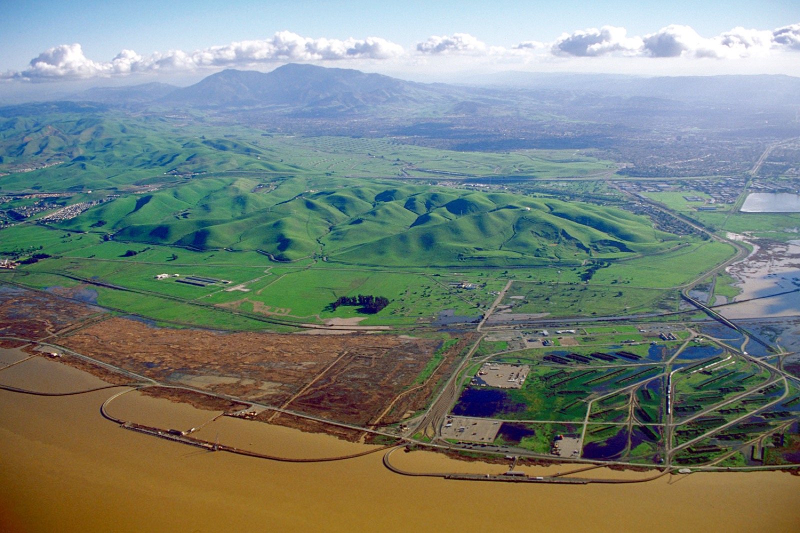 Aerial view of the former Concord Naval Weapons Station lands with Mount Diablo behind, a job site area we serve, The Lavatory NorCal