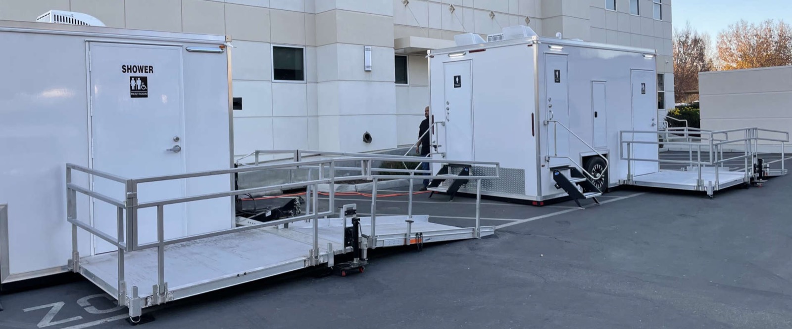Accessible shower and bathroom trailers with ramps outside a corporate office, The Lavatory NorCal