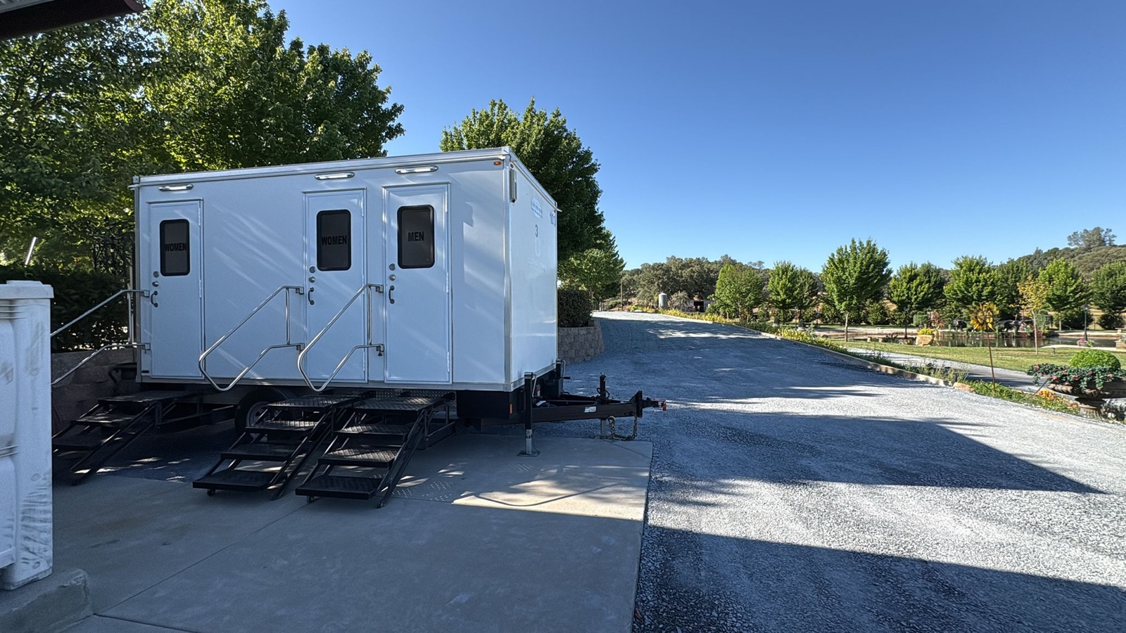 3-stall bathroom trailer on a concrete pad at a foothill event venue in Auburn, The Lavatory NorCal