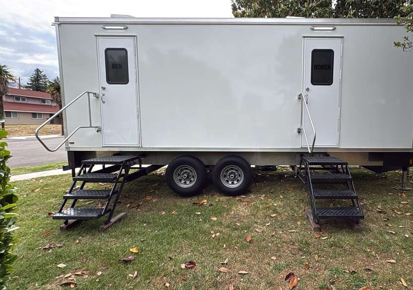 9-stall restroom trailer with men's and women's stairs set on a lawn in a San Jose neighborhood, The Lavatory NorCal