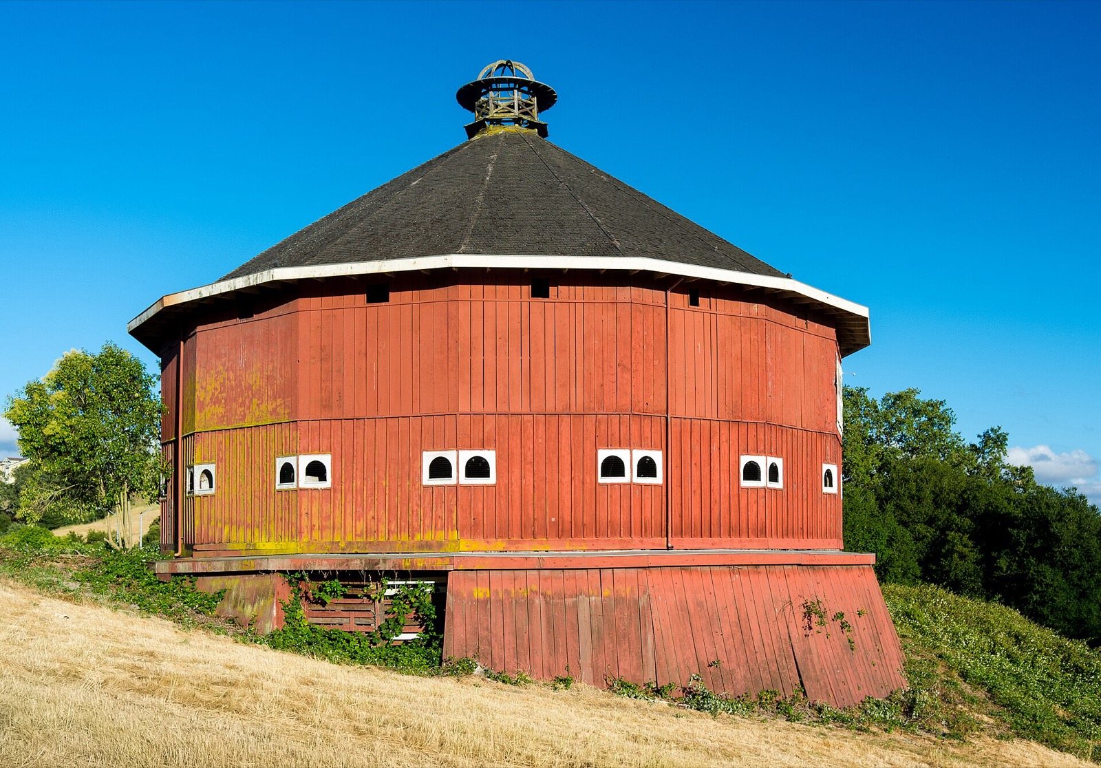 Red Fountaingrove Round Barn on a dry hillside in Santa Rosa, near hillside homes we serve, The Lavatory NorCal