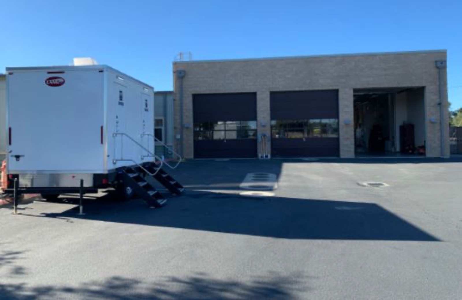 Shower trailer staged on the apron of a fire station for crews coming off shift, The Lavatory NorCal