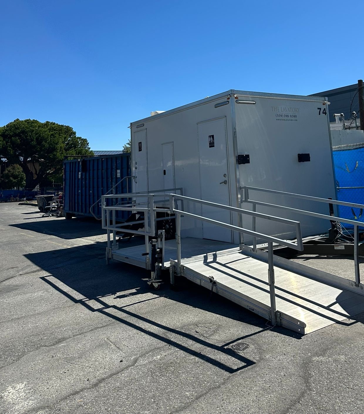 ADA plus 2 bathroom trailer with an aluminum ramp on a Sunnyvale construction lot near the town center, The Lavatory NorCal