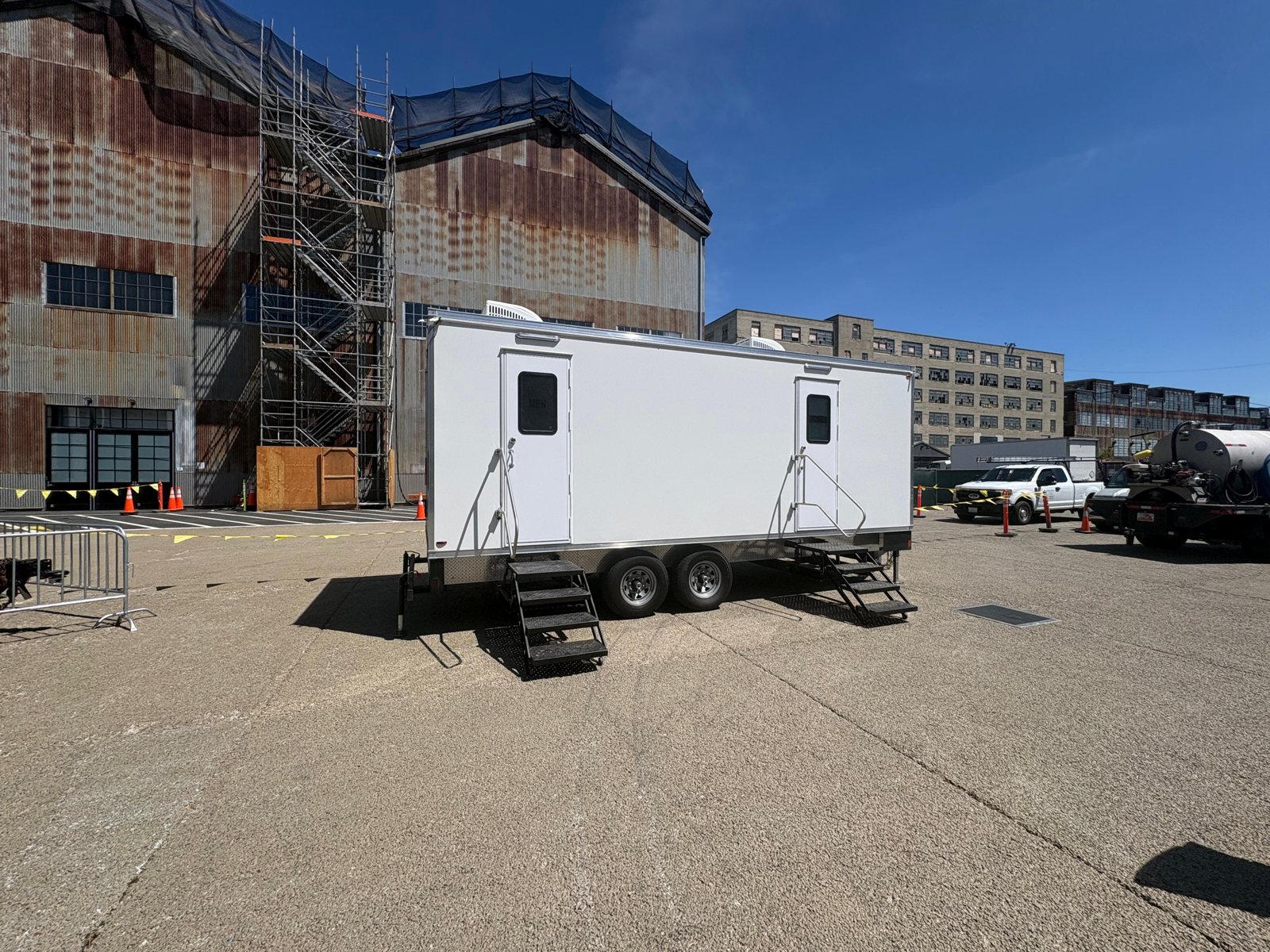 A Lavatory luxury restroom trailer set up for an event in Antioch, California, with flushing china toilets, running water, and climate control inside