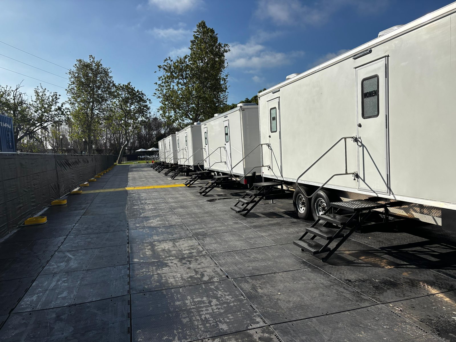 A Lavatory luxury restroom trailer set up for an event in Citrus Heights, California, with flushing china toilets, running water, and climate control inside
